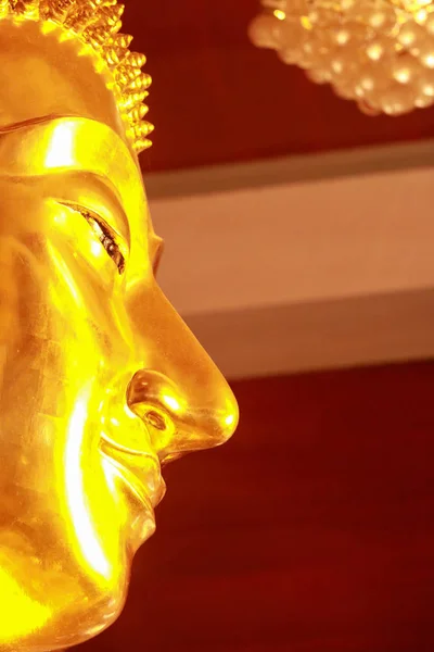 Close up of Buddha face statue.