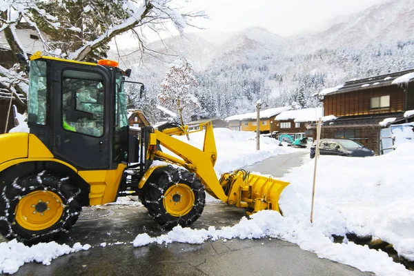 snow loader for removes snow on the road in the village