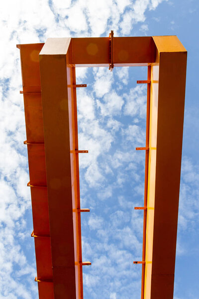 Detail steel of Crane in front of a blue sky.