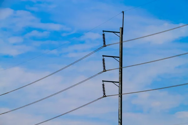 electric pole with electric cable on the blue sky background