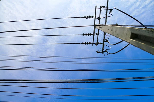 Electric pole with electric cable on the blue sky background