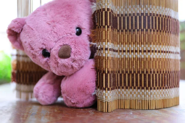 Cute teddy bear on wood background