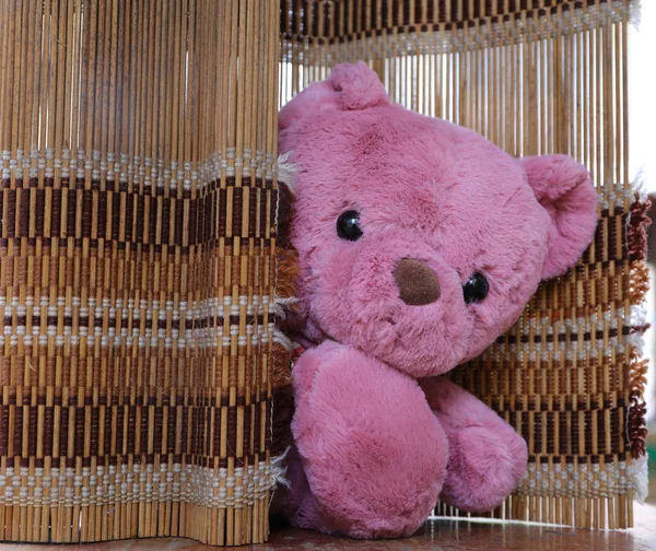 Cute teddy bear on wood background