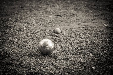 Closeup of bocce balls or Metallic petanque balls on fine stone field clipart