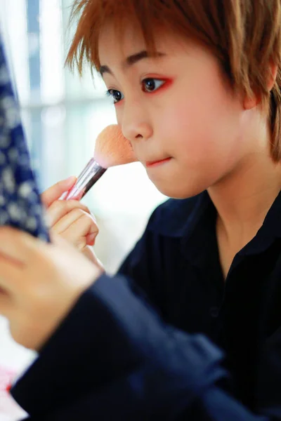 Makeup applying for perfect skin.Beautiful girl with cosmetic powder brush for make up.