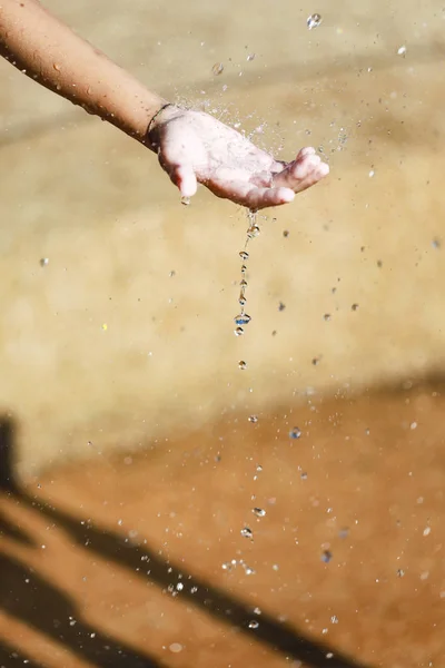 Water Pouring in Child 's Hands — стоковое фото
