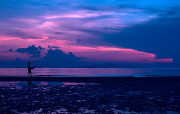 황혼의 하늘과 해변에서 서핑 보드와 남자의 실루엣 — 스톡 사진