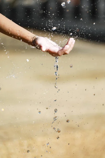 L'eau coulant dans les mains de l'enfant — Photo