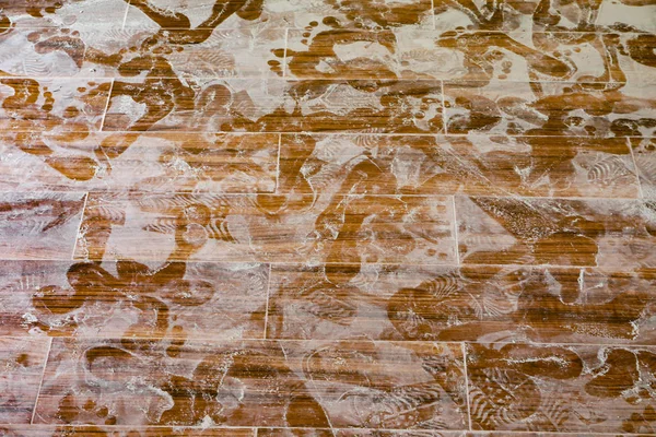 Footprints on tile floor — Stock Photo, Image