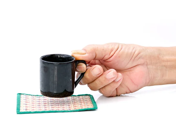 Hand hold with black cup on the white table — Stock Photo, Image