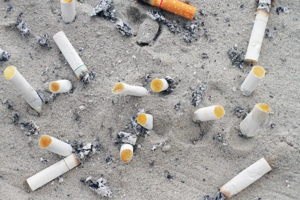 Cigarette butt cigarette on Ashtray with sand and cigarette stub — Stock Photo, Image