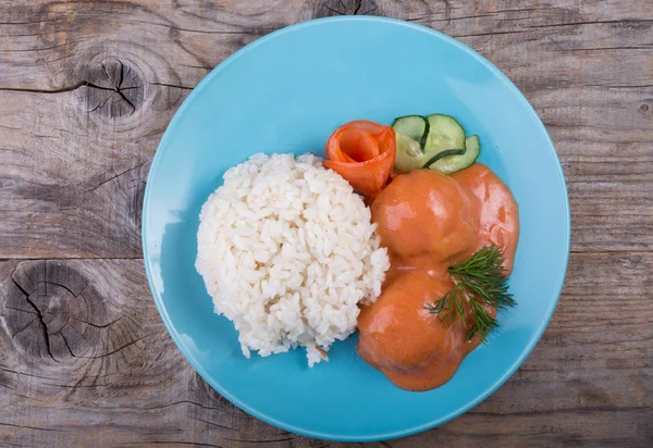 Rice with meat cutlets served on a blue platev