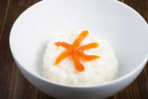 Rice porridge with apricots served in a bowl