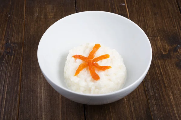 Rice porridge with apricots served in a bowl