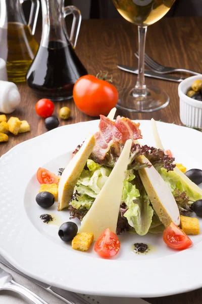 stock image Caesar salad with croutons, cheese and grilled chicken served on a table