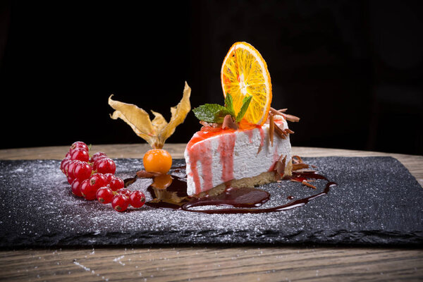 Slice of cheesecake served with red currant