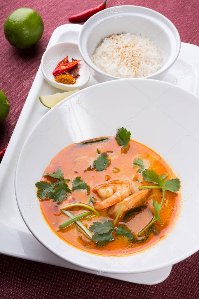 Thai tom yum soup served with rice and chili