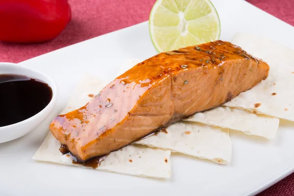 Baled salmon steak served with lime — Stock Photo, Image