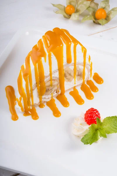 White spoonge peice of cake with orange syrup — Stock Photo, Image