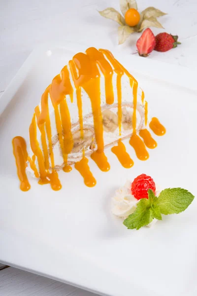 White spoonge peice of cake with orange syrup — Stock Photo, Image