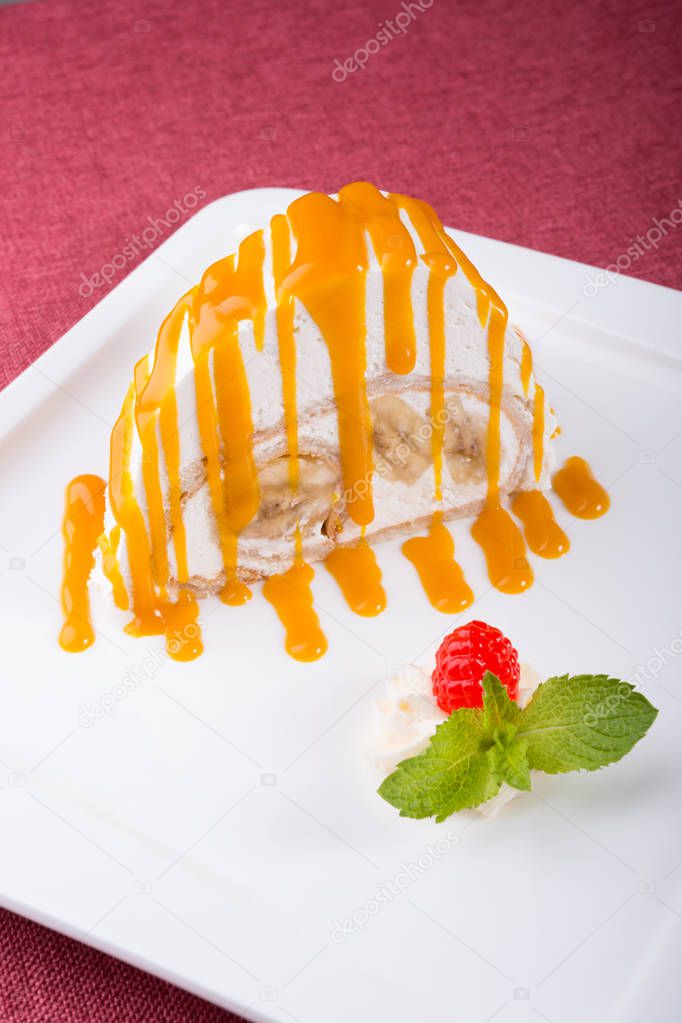 White spoonge peice of cake with orange syrup