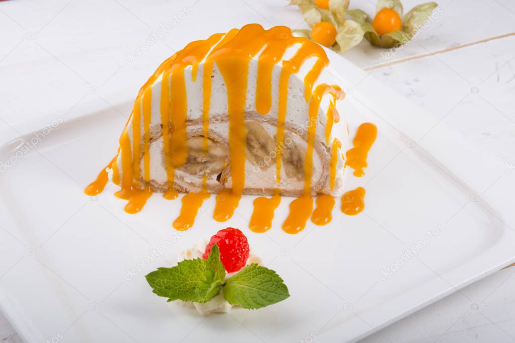 White spoonge peice of cake with orange syrup