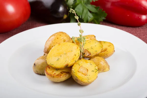 Baked yellow potatoes as garnish served with thyme — Stock Photo, Image