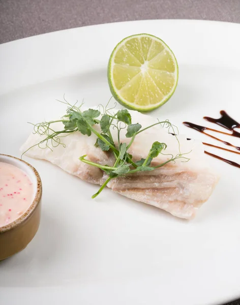 White fish fillet served with lime