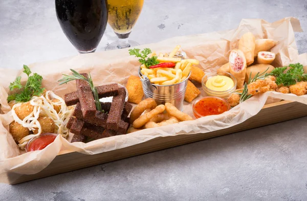 Different beer snacks served on a platter — Stock Photo, Image