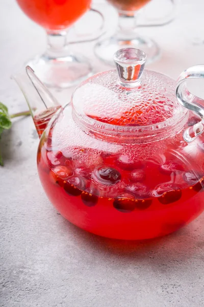 Transparent glass teapot with red hot fruit tea — Stock Photo, Image