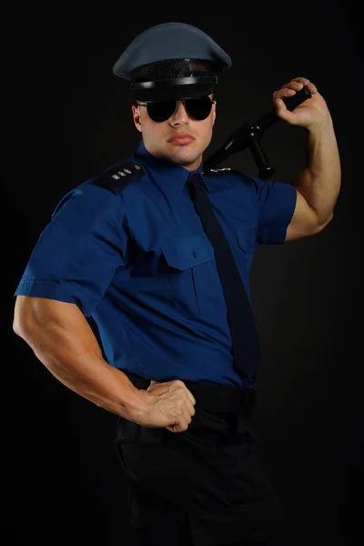 Policia muscular com bastão — Fotografia de Stock