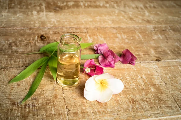 Essential Oil Small Glass Bottle Bamboo Leaves Bougainvillea Frangipani Flowers — Stock Photo, Image