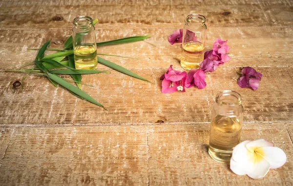 Essential Oil Small Glass Bottles Bamboo Leaves Bougainvillea Frangipani Flowers — Stock Photo, Image