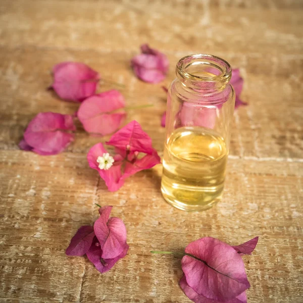 Close Essential Oil Small Glass Bottle Bougainvillea Flowers Wooden Background — Stock Photo, Image