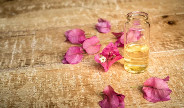 Close Essential Oil Small Glass Bottle Bougainvillea Flowers Wooden Background — Stock Photo, Image