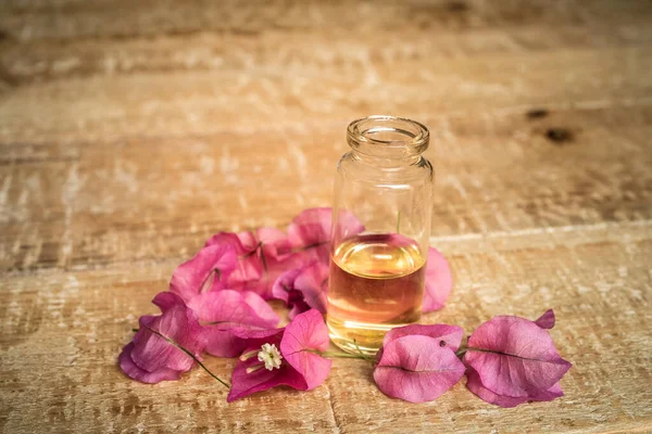 Close Essential Oil Small Glass Bottle Bougainvillea Flowers Wooden Background — Stock Photo, Image