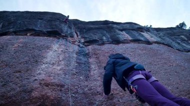 Dişi arkadaşlar gerçek kayaya tırmanıyorlar. Yüksek kalite 4k görüntü