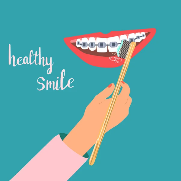 歯ブラシで笑顔 歯の健康日常生活の概念 竹歯ブラシで人間の手のクリーニング歯 口腔ケア 一口の修正と美しい笑顔 診療所のベクトルコンセプト — ストックベクタ