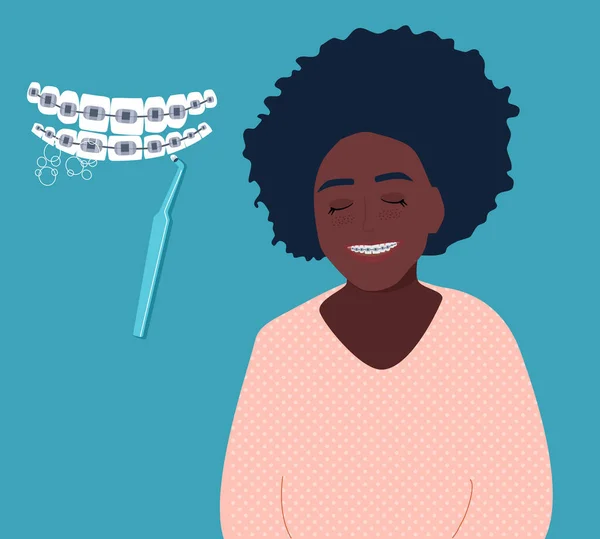 歯にデンタルブレースをつけて笑っている可愛いアフロ系アメリカ人の少女 口腔日常衛生とケア美しい健康的な笑顔 クリニックのためのベクトル — ストックベクタ