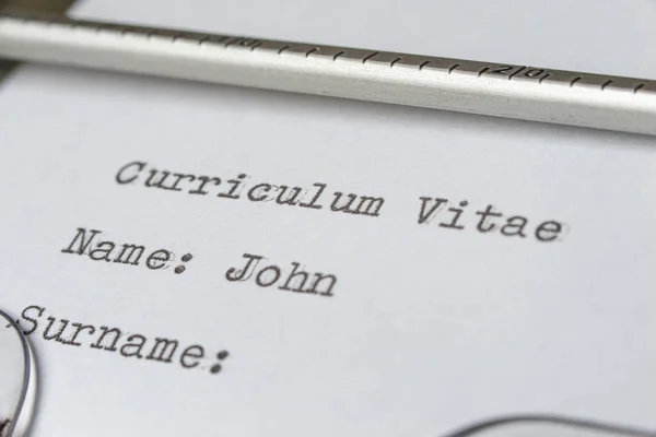 Writing a Curriculum Vitae, using a typewriter