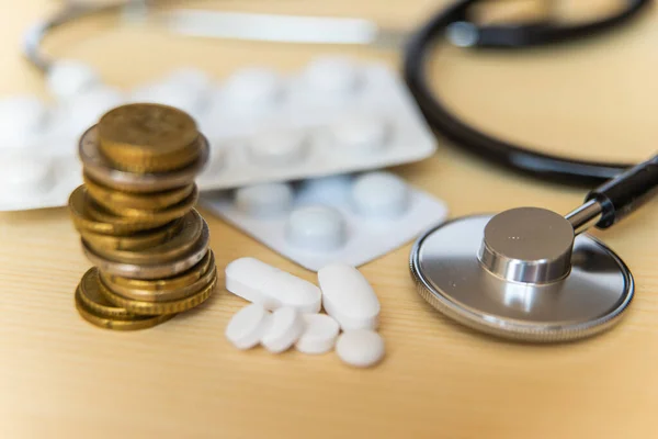 Stethoscope, medicine and money: health costs.