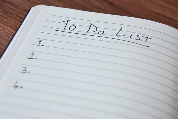 List of things to do written in a striped notebook