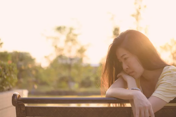 Asian woman sitting alone and depressed,stop abusing domestic violence, health anxiety.