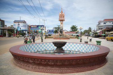 CAMBODIA, KAMPONG THOM - NOVEMBER, 2017: Clock tower and the Elephant stepping on Tiger Monument in the city centre of Kampong Thom of Cambodia clipart