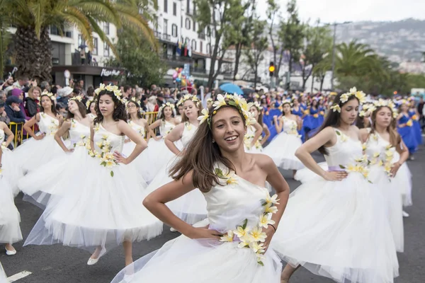 stock image women dressed in colorful clothes at the Festa da Flor or Spring Flower Festival in the city of Funchal on the Island of Madeira in the Atlantic Ocean of Portugal.  Madeira, Funchal, April, 2018