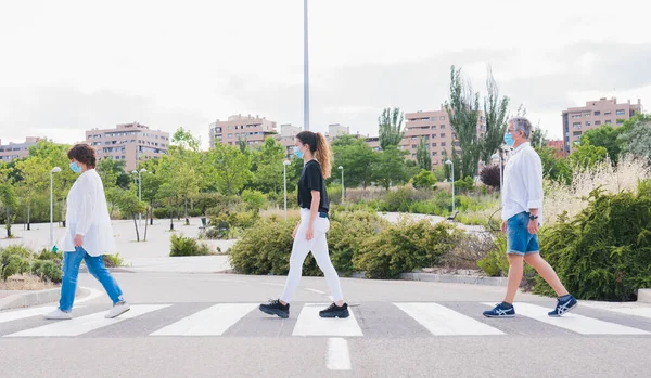 New normal. Human life in Social distance. People walking through a pedestrian crossing wearing masks while keeping a safe distance. Safety and pandemic concept. Coronavirus. Social distance.