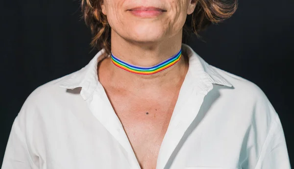 Decorative makeup with a gay pride theme.Gay pride choker. Lady's neck with gay pride makeup. Gay pride devices. Rainbow flag. Rainbow flag clothing. Old lady with rainbow flag.