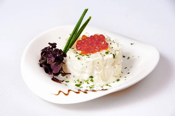 Beyaz arka planda havyarlı patates salatası.