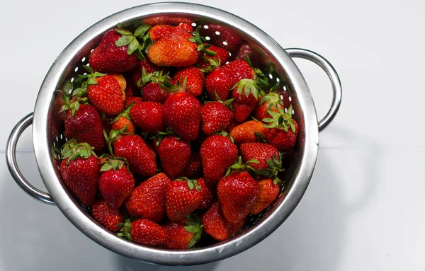 Fresh strawberries in a colander isolated on white background — Stock Photo, Image