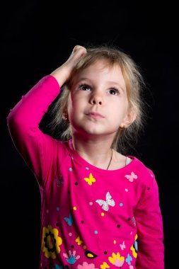 Duygu kavramı: ilgili küçük kız. Siyah arka plan, studio fotoğraf.